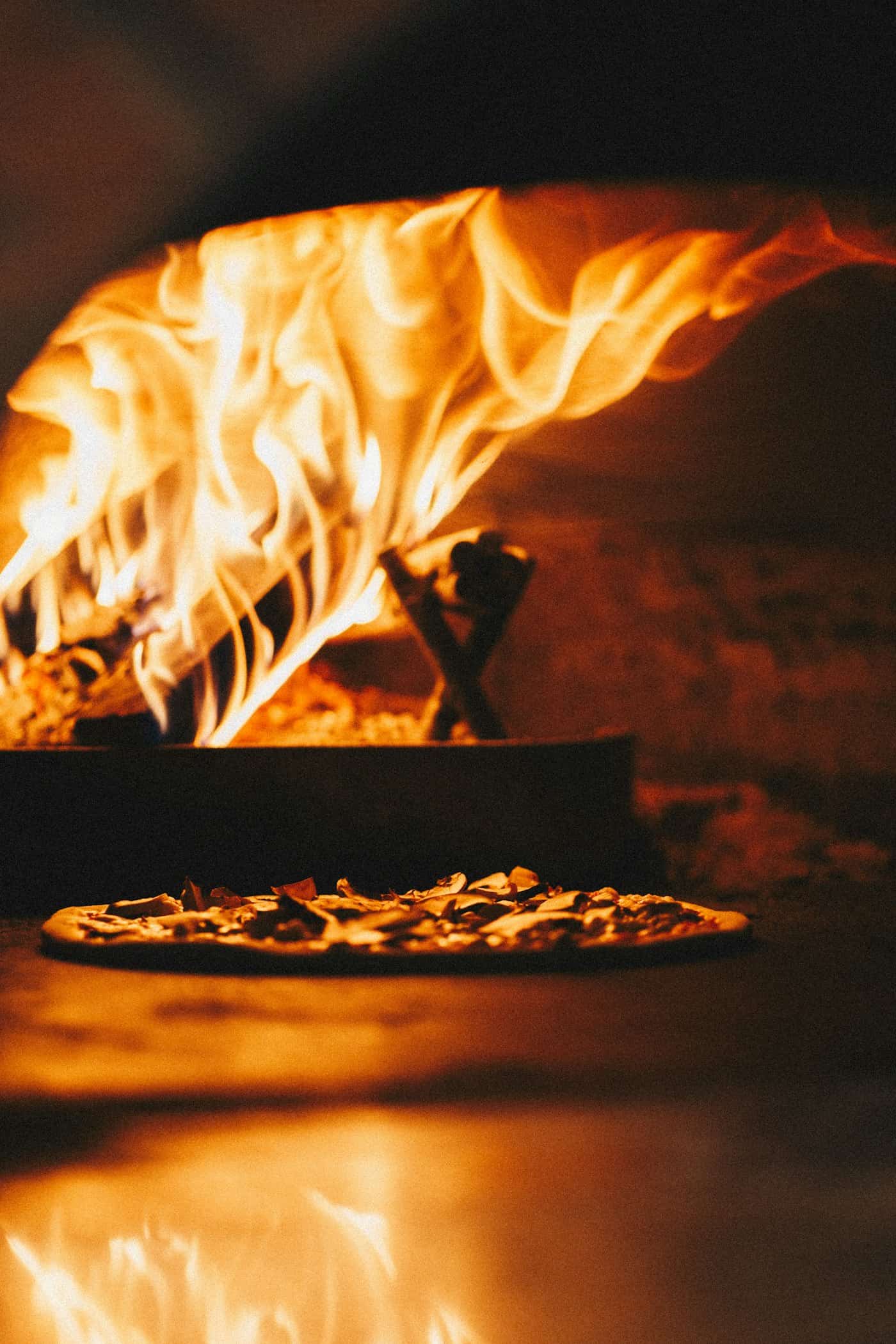 Open flames burning inside a round wood-fired oven