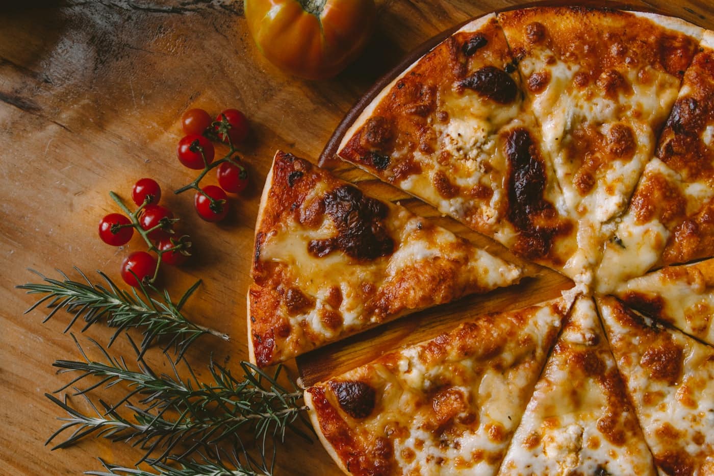 Overhead shot of a freshly baked pizza on a rustic wooden table