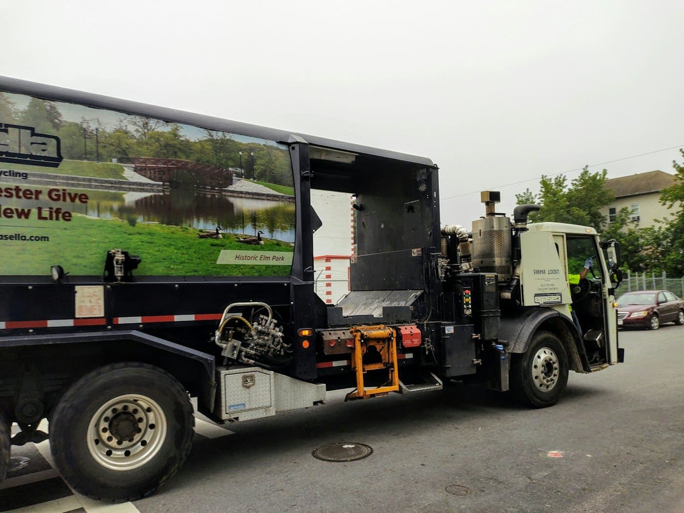 Black and white work truck on a road during daytime