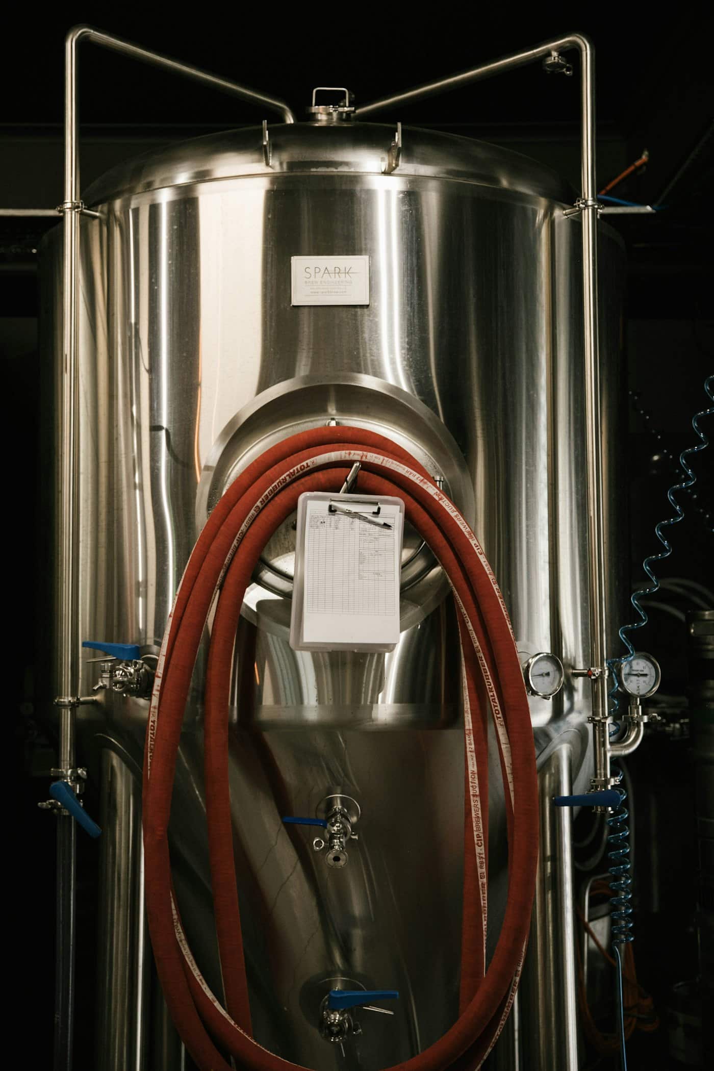 Tall gray stainless-steel brewery fermentation tank